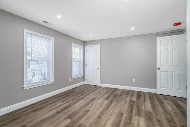 70 Sanborn St, Fitchburg, MA 01420 - unfurnished bedroom featuring wood finished floors, baseboards, recessed lighting, and a closet