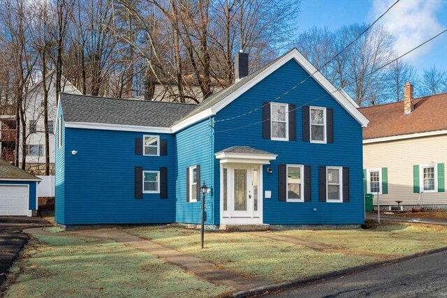 70 Sanborn St, Fitchburg, MA 01420 - traditional-style house featuring a chimney, a front lawn, and an outdoor structure