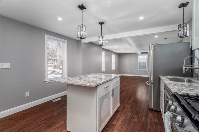 70 Sanborn St, Fitchburg, MA 01420 - kitchen featuring stainless steel gas range oven, baseboards, a center island, light stone countertops, and recessed lighting