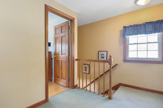 hallway featuring light colored carpet