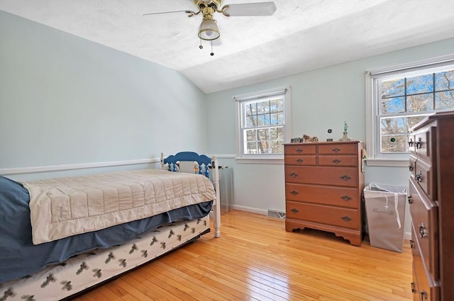 bedroom featuring lofted ceiling, ceiling fan, and light wood-type flooring