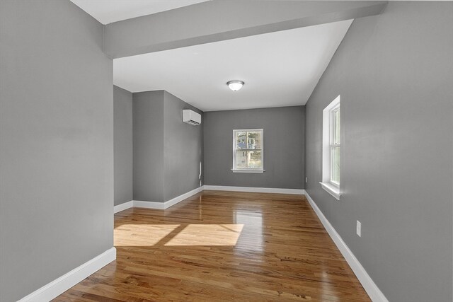 spare room with hardwood / wood-style flooring and a wall mounted AC