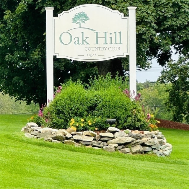 community / neighborhood sign with a lawn