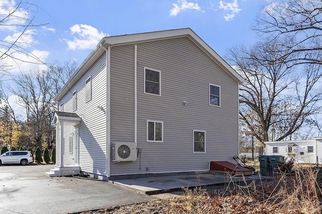 back of property with a patio and ac unit