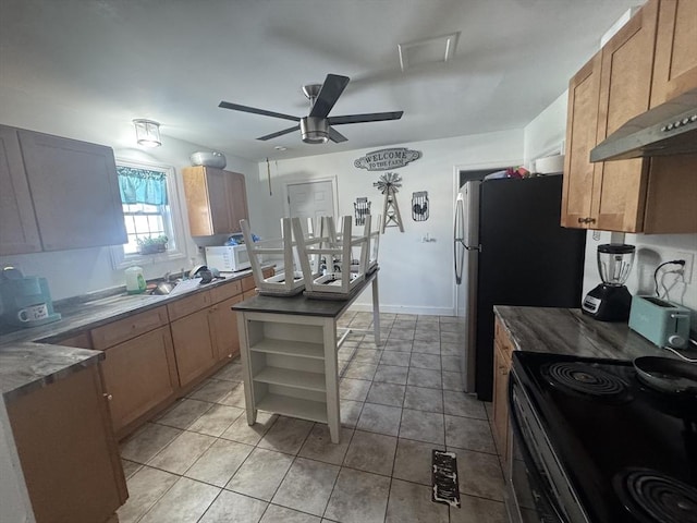 kitchen with white microwave, under cabinet range hood, a ceiling fan, and light tile patterned flooring