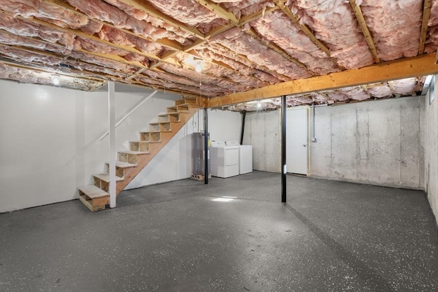 unfinished below grade area with stairway, water heater, and washing machine and dryer
