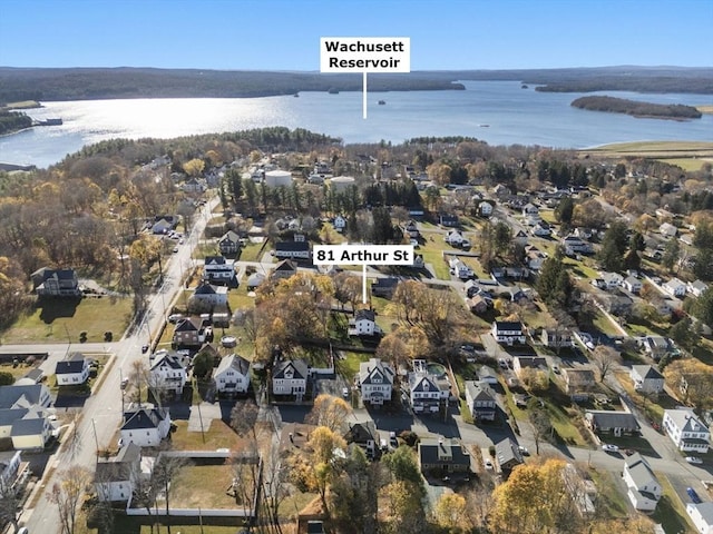 drone / aerial view featuring a residential view and a water view