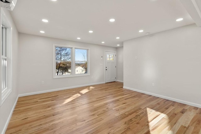 interior space featuring recessed lighting, baseboards, and light wood-style floors