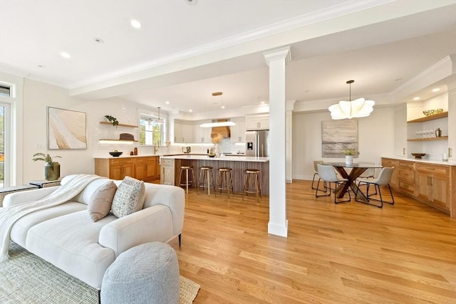 3 Colburn St Unit 1, Gloucester, MA 01930 - living area with ornamental molding, recessed lighting, light wood-style flooring, and decorative columns