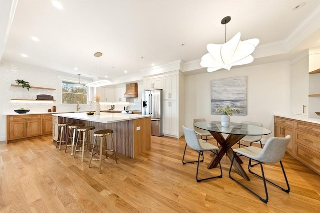 3 Colburn St Unit 1, Gloucester, MA 01930 - kitchen with high end fridge, a center island, premium range hood, light countertops, and open shelves