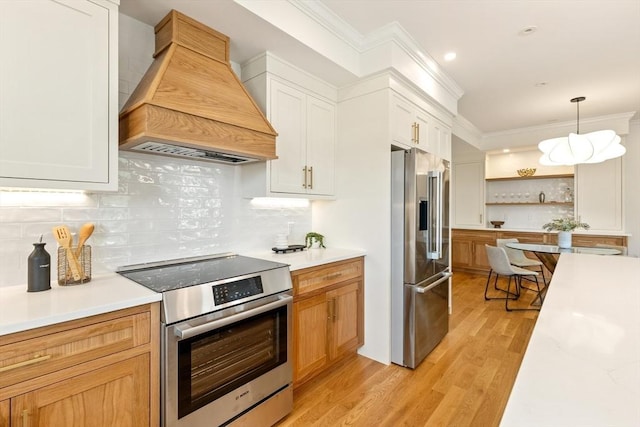 3 Colburn St Unit 1, Gloucester, MA 01930 - kitchen with appliances with stainless steel finishes, custom range hood, open shelves, ornamental molding, and light countertops