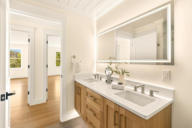 3 Colburn St Unit 1, Gloucester, MA 01930 - bathroom with double vanity, ornamental molding, and wood finished floors