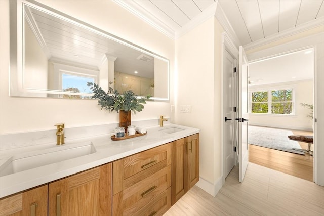 3 Colburn St Unit 1, Gloucester, MA 01930 - bathroom with ornamental molding, double vanity, and wood finished floors