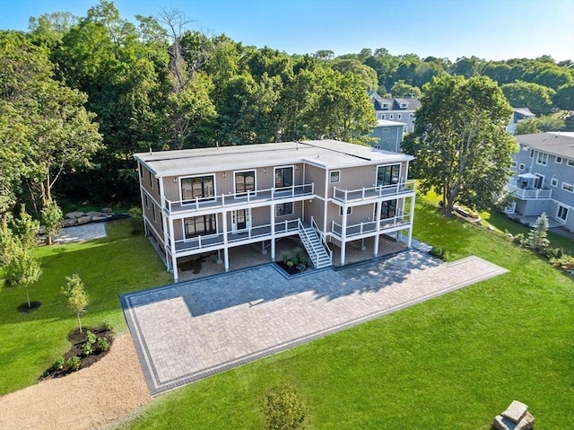 3 Colburn St Unit 1, Gloucester, MA 01930 - rear view of house with a balcony, a lawn, and driveway