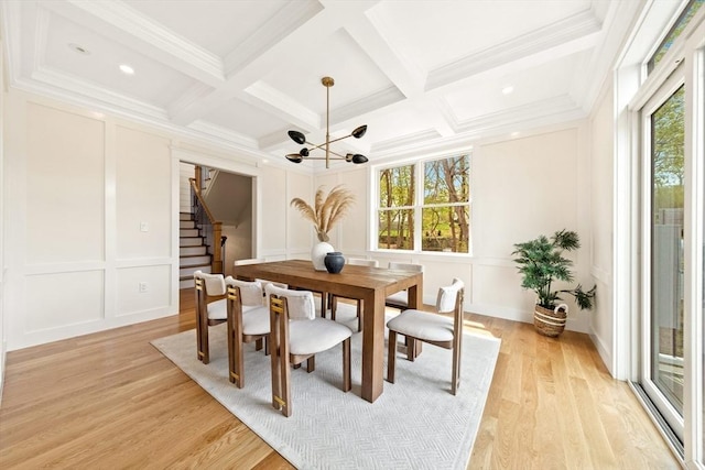 3 Colburn St Unit 1, Gloucester, MA 01930 - dining area with a decorative wall, stairs, a chandelier, beamed ceiling, and coffered ceiling
