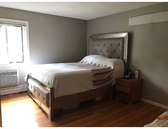 5 Hallmark Gdns Unit 6, Burlington, MA 01803 - bedroom featuring light wood finished floors, a baseboard radiator, and a wall unit AC