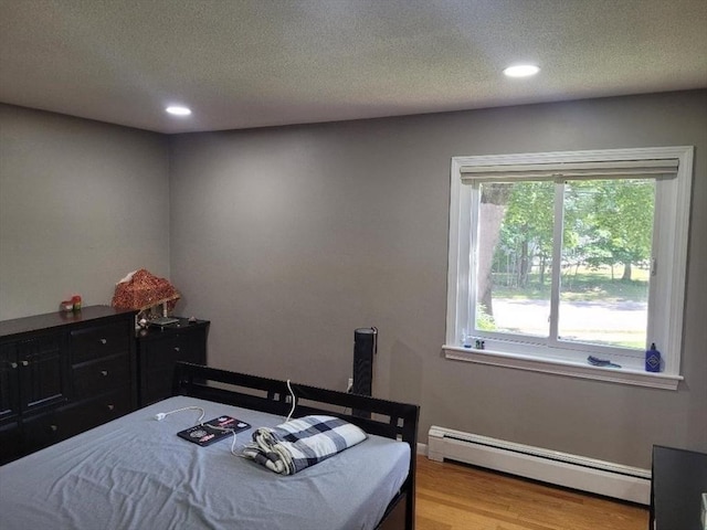 5 Hallmark Gdns Unit 6, Burlington, MA 01803 - bedroom featuring baseboard heating, wood finished floors, a textured ceiling, and recessed lighting