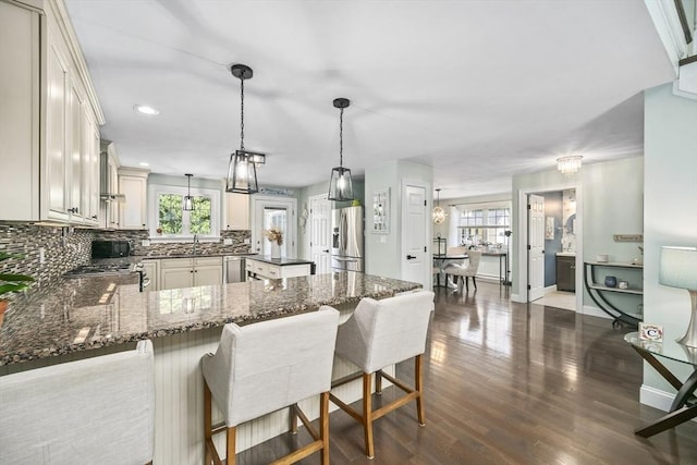 1 Woodland Ct Unit B, Milford, MA 01757 - kitchen with stainless steel fridge with ice dispenser, decorative backsplash, a peninsula, dark wood-style flooring, and dark stone counters