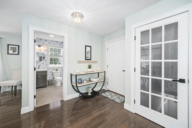 1 Woodland Ct Unit B, Milford, MA 01757 - foyer entrance with wood finished floors and a chandelier