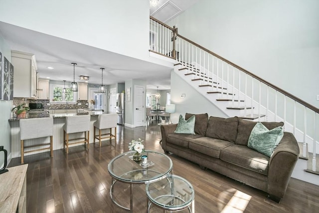 1 Woodland Ct Unit B, Milford, MA 01757 - living area featuring dark wood-type flooring, stairs, and a high ceiling