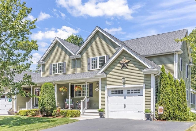 1 Woodland Ct Unit B, Milford, MA 01757 - traditional home with a porch, asphalt driveway, a shingled roof, and a front yard
