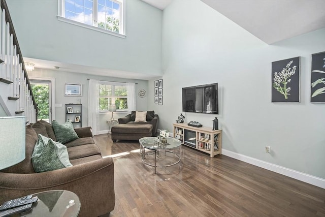 1 Woodland Ct Unit B, Milford, MA 01757 - living area with stairway, a towering ceiling, and wood finished floors