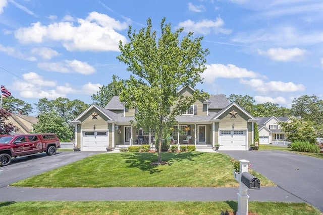 1 Woodland Ct Unit B, Milford, MA 01757 - view of front of home featuring a front yard, driveway, covered porch, and a garage