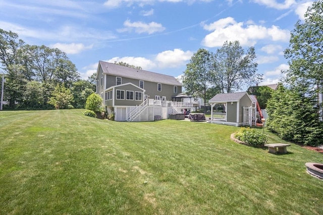 1 Woodland Ct Unit B, Milford, MA 01757 - back of house featuring an outbuilding, stairs, a lawn, and a deck