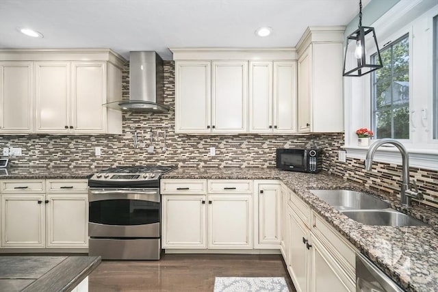 1 Woodland Ct Unit B, Milford, MA 01757 - kitchen with appliances with stainless steel finishes, wall chimney exhaust hood, dark wood-style floors, dark stone counters, and tasteful backsplash