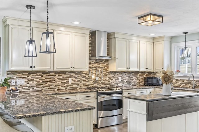 1 Woodland Ct Unit B, Milford, MA 01757 - kitchen featuring gas range, wall chimney range hood, a peninsula, decorative backsplash, and recessed lighting