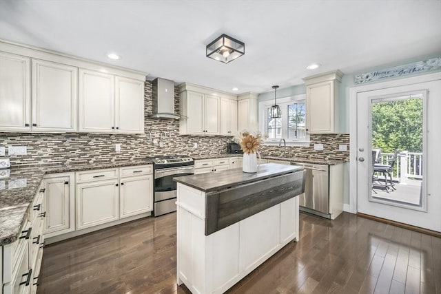 1 Woodland Ct Unit B, Milford, MA 01757 - kitchen with wall chimney range hood, stainless steel appliances, tasteful backsplash, dark wood-style floors, and recessed lighting