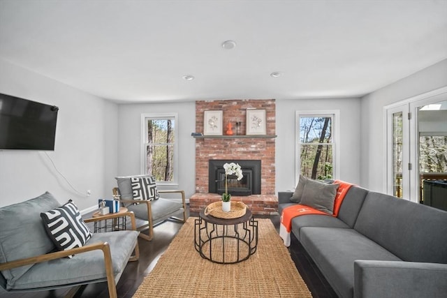 65 Sheffield Ter, Marlborough, MA 01752 - living area featuring wood finished floors, healthy amount of natural light, a fireplace, baseboards, and recessed lighting