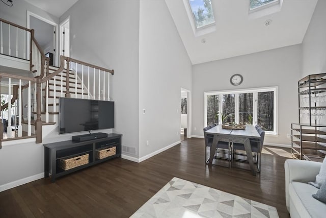 65 Sheffield Ter, Marlborough, MA 01752 - living room with high vaulted ceiling, wood finished floors, baseboards, and a skylight