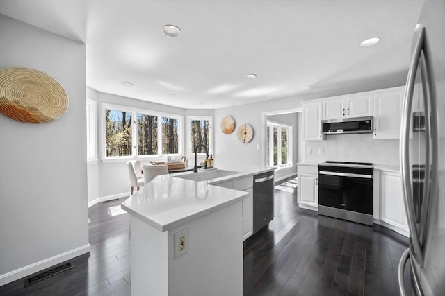 65 Sheffield Ter, Marlborough, MA 01752 - kitchen featuring appliances with stainless steel finishes, a sink, light countertops, recessed lighting, and dark wood finished floors