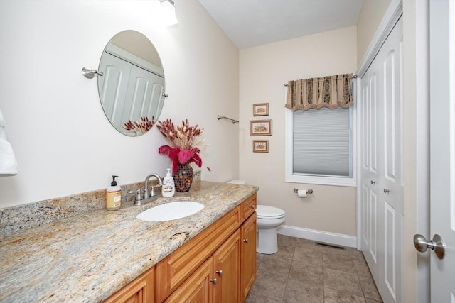 bathroom featuring tile patterned floors, vanity, and toilet