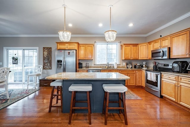 kitchen featuring light wood-type flooring, a center island, and stainless steel appliances