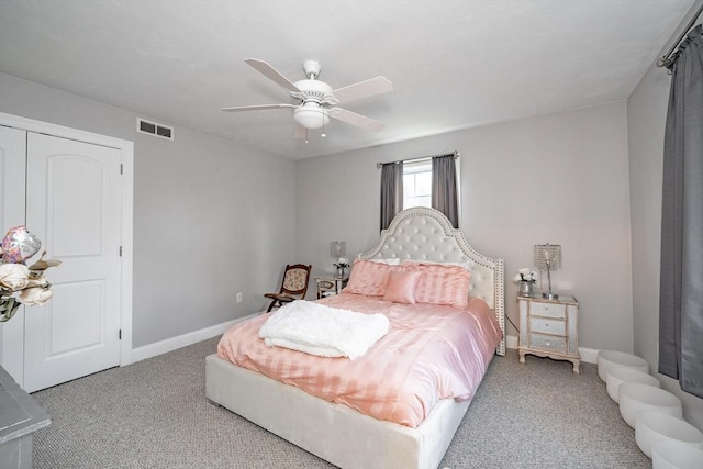 carpeted bedroom featuring ceiling fan and a closet