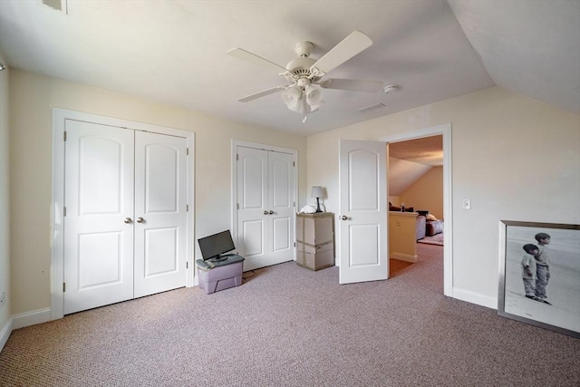 unfurnished bedroom featuring carpet flooring, vaulted ceiling, and ceiling fan