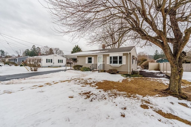 bungalow-style home with fence