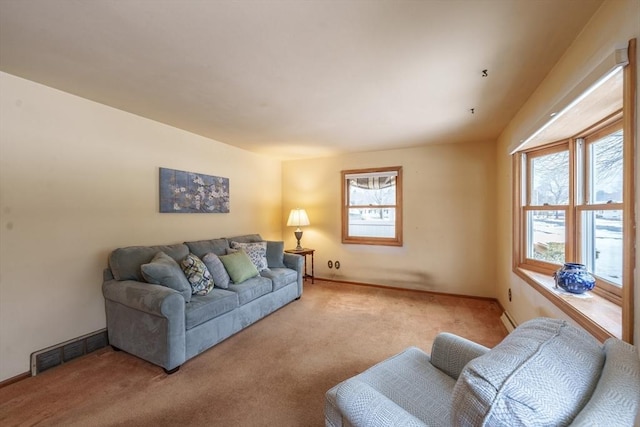 living room with baseboards, visible vents, and light colored carpet