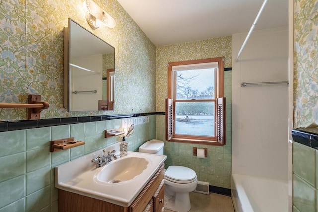 full bathroom featuring toilet, wallpapered walls, visible vents, and vanity