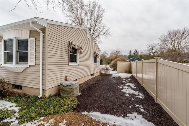 view of side of home with fence