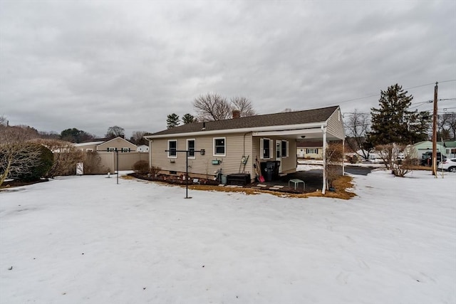 snow covered property with fence