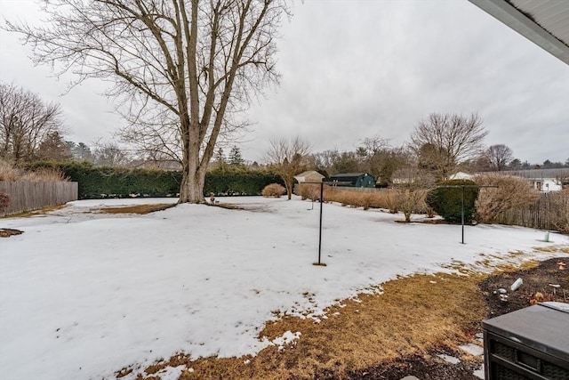 yard layered in snow with fence