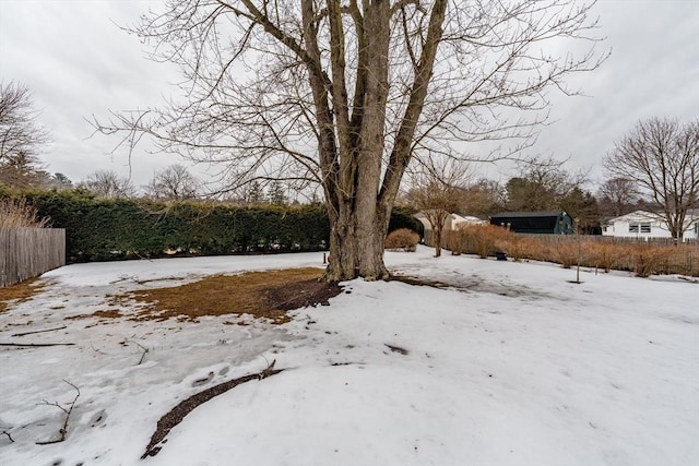 yard covered in snow with fence