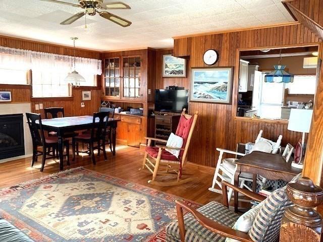 114 Long Bch, Rockport, MA 01966 - dining space with wooden walls, ceiling fan, and wood finished floors