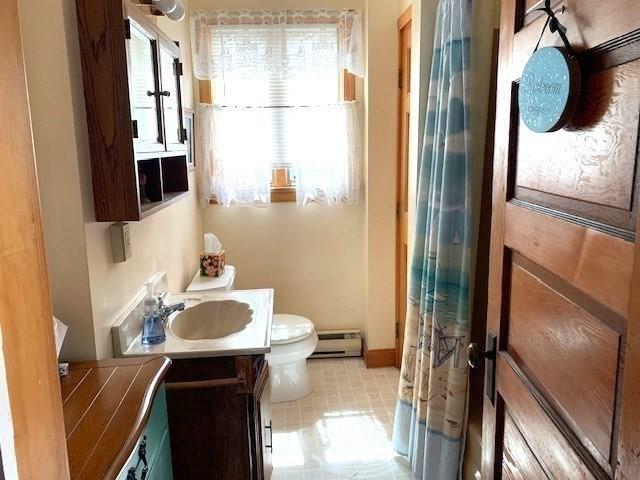 114 Long Bch, Rockport, MA 01966 - bathroom featuring healthy amount of natural light, a baseboard heating unit, toilet, and vanity