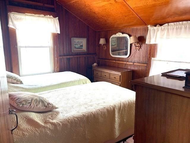 114 Long Bch, Rockport, MA 01966 - bedroom with multiple windows, wooden walls, lofted ceiling, and wood ceiling