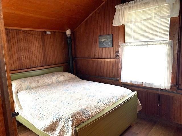 114 Long Bch, Rockport, MA 01966 - bedroom with wood walls, wooden ceiling, vaulted ceiling, and wood finished floors