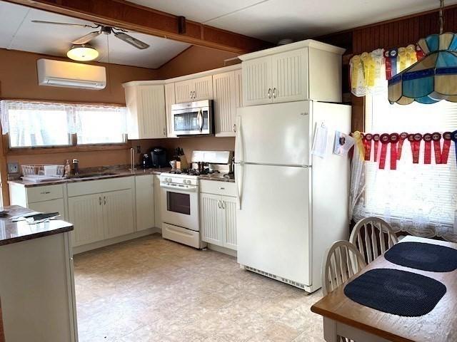 114 Long Bch, Rockport, MA 01966 - kitchen with white appliances, a sink, dark countertops, a ceiling fan, and light flooring